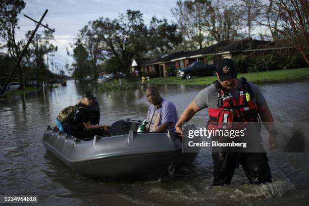 First responders rescue a resident from floodwater left behind by Hurricane Ida in LaPlace, Louisiana, U.S., on Monday, Aug. 30, 2021. The storm,...