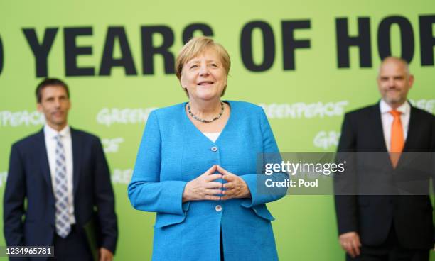 German Chancellor Angela Merkel poses with Burkard Baschek, Scientific Director of Deutsches Meeresmuseum Ozeaneum Stralsund at the live streamed...