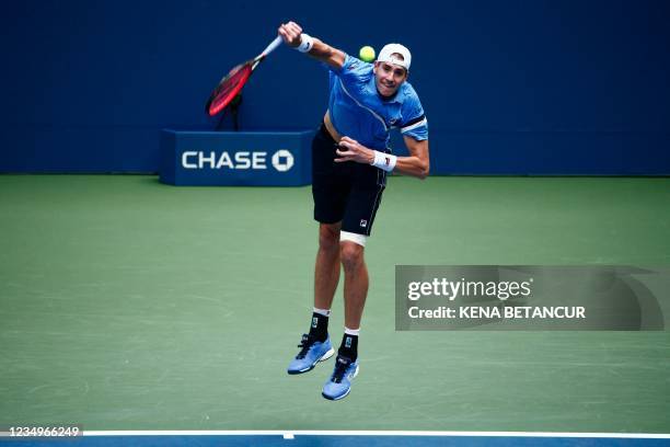 Player John Isner serves to US player Brandon Nakashima during their 2021 US Open Tennis tournament men's singles first round match at the USTA...