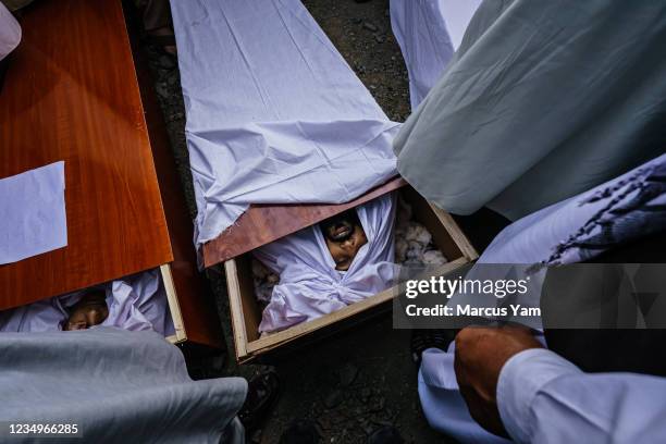 Caskets left open for viewing at the mass funeral for the 10 people the Ahmadi family said were killed in a U.S. Drone strike, in Kabul, Afghanistan,...