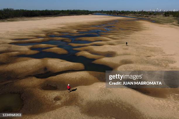 Aerial view of people walking along an almost dry arm of the Parana River, which water level reached a historic low, near Rosario, Santa Fe,...