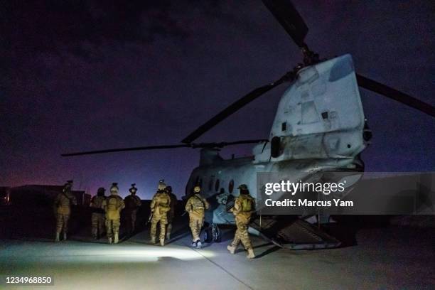 Taliban fighters from the Fateh Zwak unit, wielding American supplied weapons, equipment and uniforms, storm into the Kabul International Airport to...