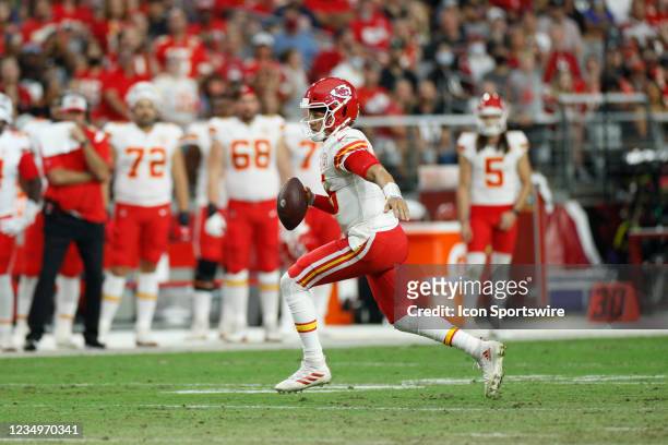 Kansas City Chiefs quarterback Patrick Mahomes runs and looks to pass as he scrambles during an NFL preseason game against the Arizona Cardinals on...