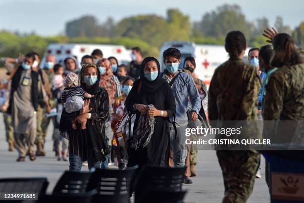 Refugees disembark from a US air force aircraft after an evacuation flight from Kabul at the Rota naval base in Rota, southern Spain, on August 31,...
