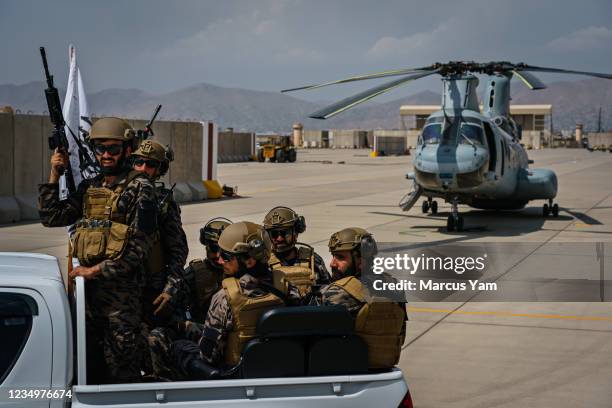 Taliban fighters take control and secure the Hamid Karzai International Airport, along with all the equipment and weapons left behind after the full...