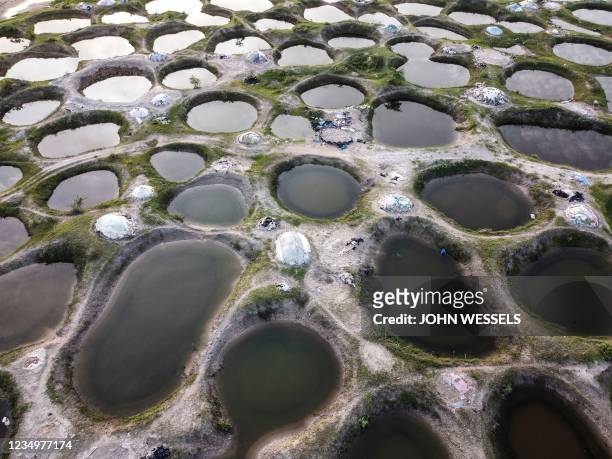 This aerial view shows flooded salt mining pits during Senegals wet season in Palmarin on August 31, 2021. - In Senegals Central and Northern regions...