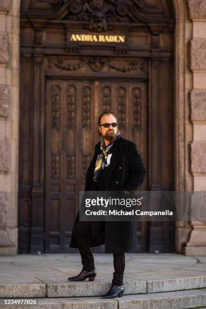 Johan Lindberg wearing BLK DNM poses for a picture outside of the Stockholm Opera House on the first day of Stockholm Fashion week on August 31, 2021...