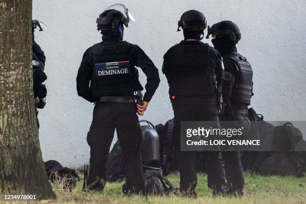 French Police minesweeper and Raid special unit stand outside a building where an alleged explosive device is supposed to be found in an apartment on...