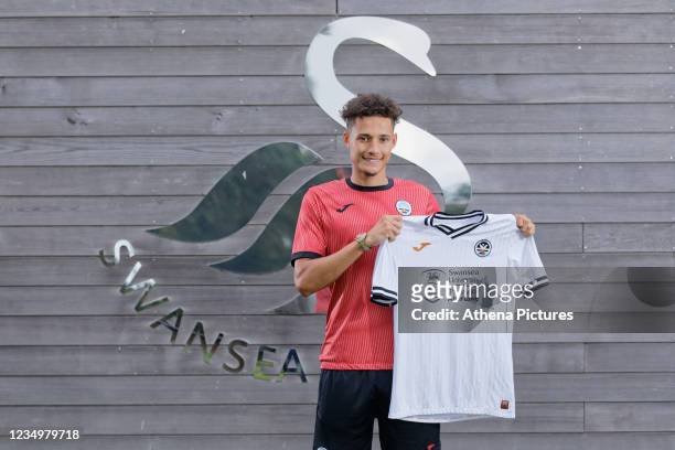 Rhys Williams poses for a portrait while holding a home shirt during his presentation at the Fairwood Training Ground on August 31, 2021 in Swansea,...