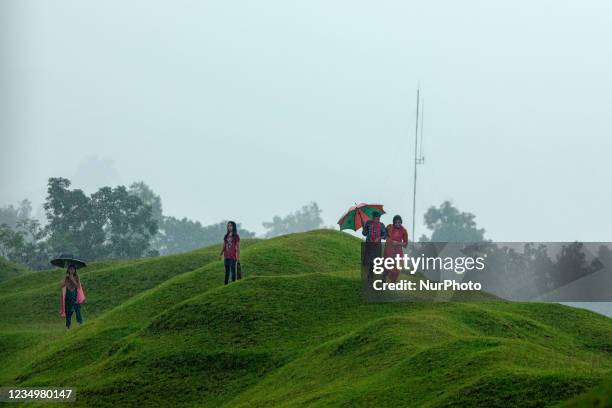 Young girls play in the rain near the Niladri lake, Tahirpur, Shunamganj.