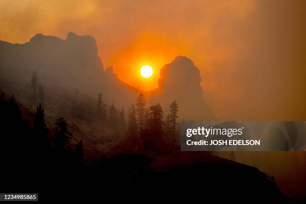 The sun sets as the Caldor fire continues to burn in Kirkwood, California on August 31, 2021. - Thousands of people were ordered to evacuate August...