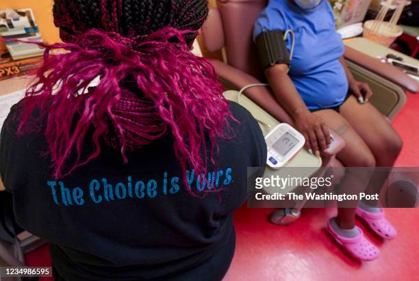 Technician wears a shirt supporting a woman's right to abortion while checking a patient's blood pressure at Jackson Women's Health Organization --...