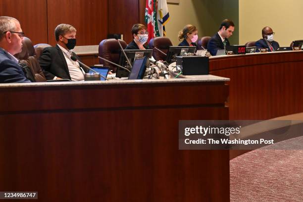 Members of the Loudoun County school board listen as virtual speakers address the board on transgender rights, covid masks and a host of other issues...