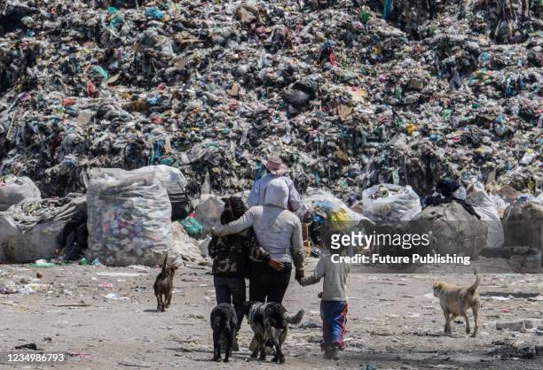 People during the collection and separation of waste that arrives daily at the largest garbage dump in Mexico Bordo de Xochiaca, which has become a...