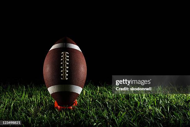 american football on a tee - football tee stock pictures, royalty-free photos & images