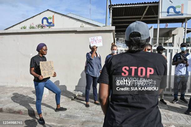 Feminist activist wearing a t-shirt that reads "stop violence against women" speaks to her comrades during a demonstration against the television...