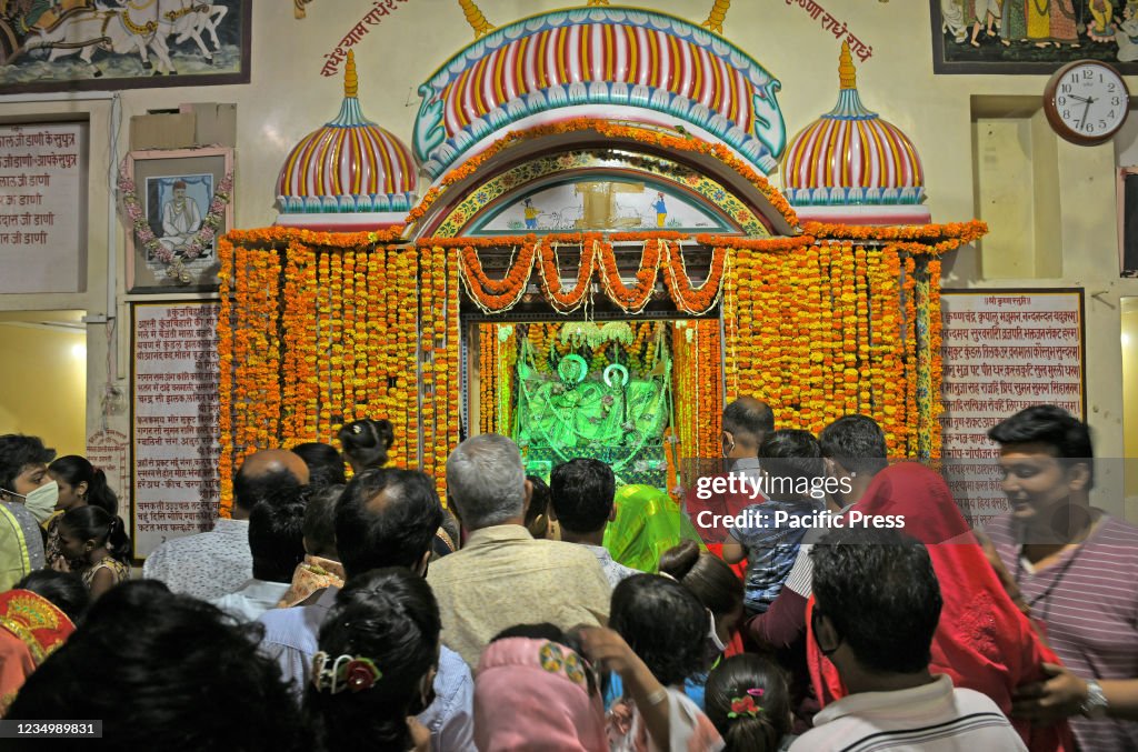 Hindu devotees offer prayers to Lord Krishna and Goddess...