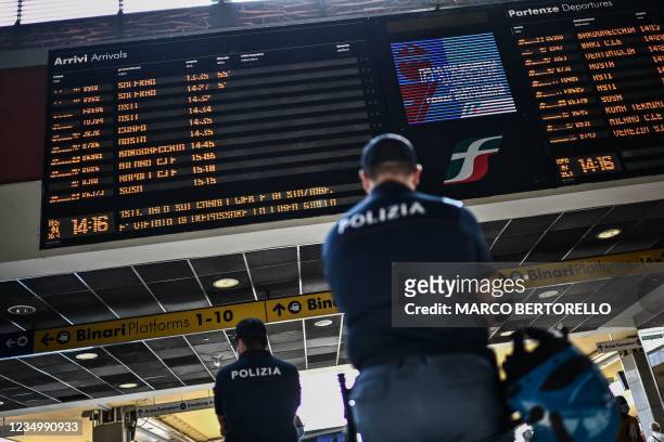 Police officers patrol on September 1, 2021 the Porta Nuova railway station in Turin. - Since early August, Italy has required proof of vaccination,...