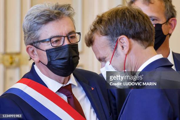 French President Emmanuel Macron speaks with French far-left La France Insoumise parliamentary group's president Jean-Luc Melenchon as he arrives at...