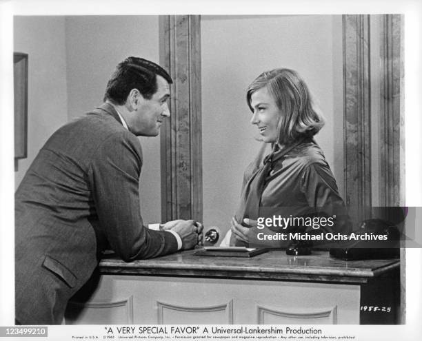 Rock Hudson talking with switchboard operator, Nita Talbot in a scene from the film 'A Very Special Favor', 1965.