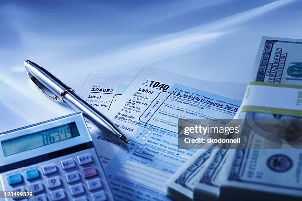 calculator, tax returns and money - 1040 stockfoto's en -beelden