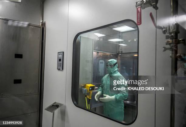 Laboratory technician prepares to work on the production of vials of China's Sinovac vaccine against the coronavirus, produced by the Egyptian...