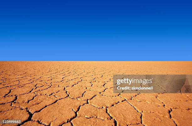 cracks in the desert and a blue sky - desert sky stock pictures, royalty-free photos & images