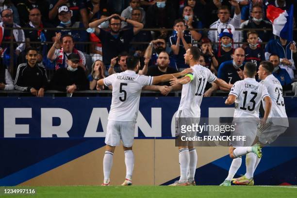 Bosnia-Herzegovina's forward Edin Dzeko celebrates after scoring a goal during the FIFA World Cup Qatar 2022 qualification Group D football match...