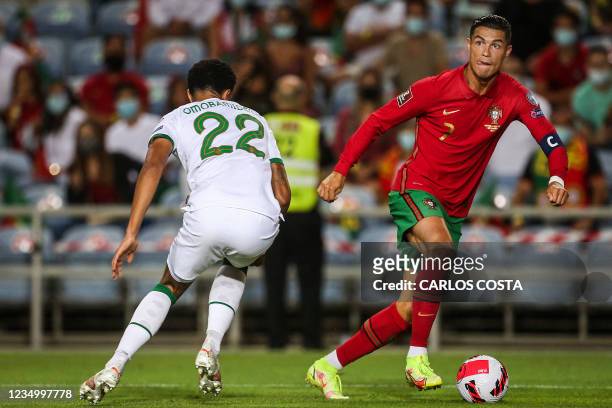 Portugal's forward Cristiano Ronaldo fights for the ball with Republic of Ireland's defender Andrew Omobamidele during the FIFA World Cup Qatar 2022...