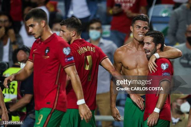Portugal's forward Cristiano Ronaldo celebrates with his teammates after scoring a goal during the FIFA World Cup Qatar 2022 European qualifying...