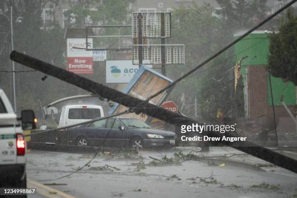 Damage, including a downed telephone pole, from a tornado is seen on West Street in Annapolis, Maryland on September 1, 2021. The remnants of...