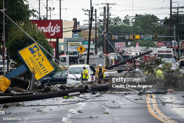 Comcast utility workers survey the damage from a tornado on West Street in Annapolis, Maryland on September 1, 2021. The remnants of Hurricane Ida...