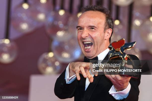 Italian actor and director, Roberto Benigni jokes as he poses for photographers after receiving a Golden Lion for lifetime achievement, following the...