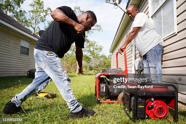 Scandar Myles and Kendrick Cook start a generator after Hurricane Ida on September 2, 2021 in Hammond, Louisiana. The storm made landfall as a...