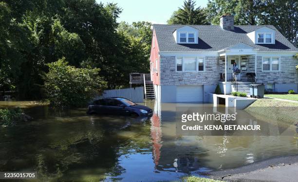 Car sits on a flooded driveway of a house following a night of heavy wind and rain from the remnants of Hurricane Ida on September 02, 2021 in...