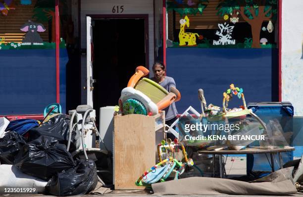 Woman removes furnitures from a daycare following a night of heavy wind and rain from the remnants of Hurricane Ida on September 02, 2021 in...