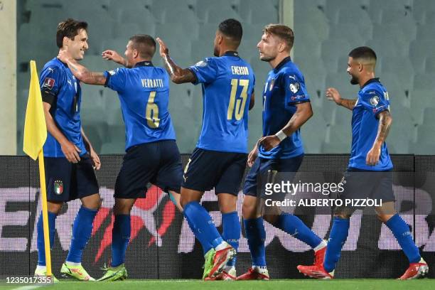 Italy's forward Federico Chiesa celebrates with teammates after scoring a goal during the FIFA World Cup Qatar 2022 qualifying round Group C football...