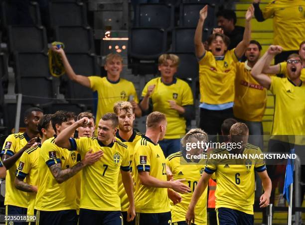 Sweden's forward Viktor Claesson celebrates scoring the 2-1 goal with team mates and fans during the FIFA World Cup Qatar 2022 qualification Group B...