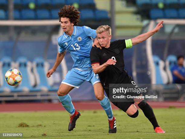 Simone Franciosi of U21 San Marino and Jonathan Burkardt of U21 Germany in action during the UEFA European Under-21 Championship Qualifier match...
