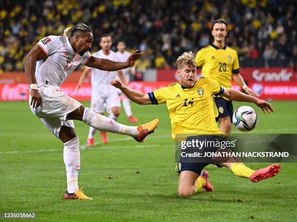 Spain's forward Adama Traore Diarra shoots past Sweden's defender Filip Helander during the FIFA World Cup Qatar 2022 qualification Group B football...