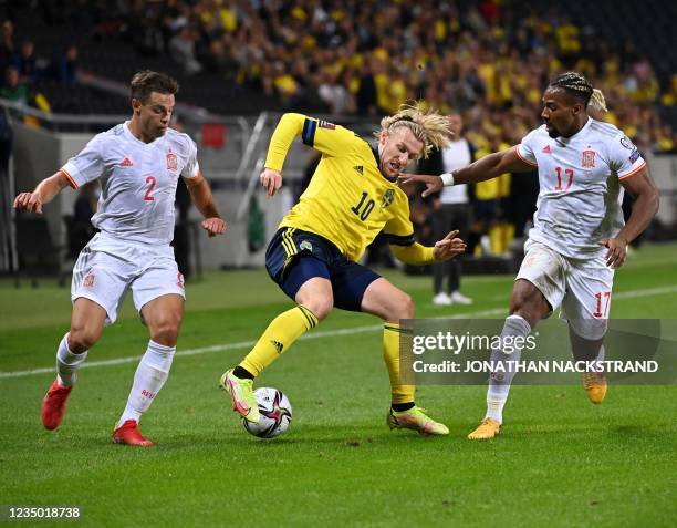 Sweden's midfielder Emil Forsberg , Spain's defender Cesar Azpilicueta and Spain's forward Adama Traore Diarra vie for the ball during the FIFA World...