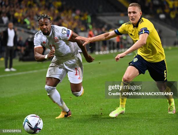 Spain's forward Adama Traore Diarra and Sweden's defender Ludwig Augustinsson vie for the ball during the FIFA World Cup Qatar 2022 qualification...