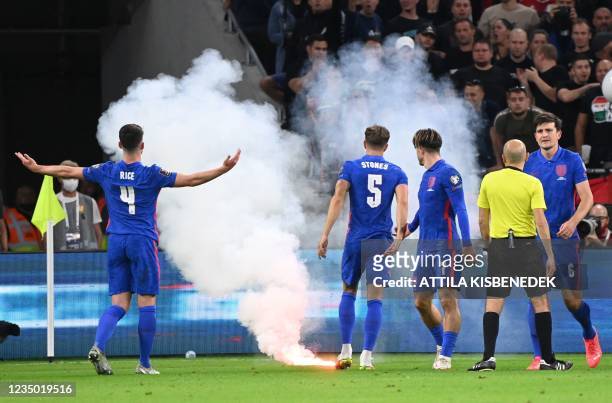 Players react as the game needs to be interrupted due to flares landing on the pitch during the FIFA World Cup Qatar 2022 qualification Group I...