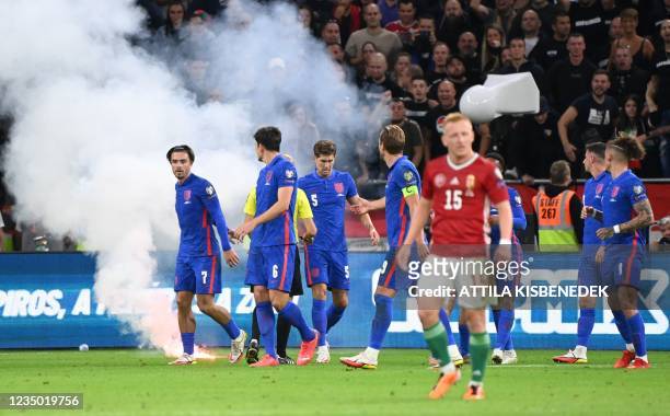 Players react as the game needs to be interrupted due to flares landing on the pitch during the FIFA World Cup Qatar 2022 qualification Group I...