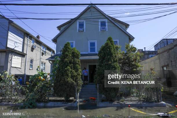 Person cleans the porch of their house after a night of high winds and rain from the remnants of Hurricane Ida on September 2, 2021 in Mamaroneck,...