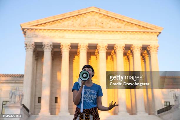 An activist, who declined to provide her name, speaks outside the Supreme Court in protest against the new Texas abortion law that prohibits the...