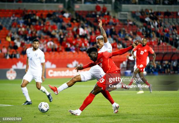 Alphonso Davies of Canada takes a shot on goal against Andy Najar of Honduras during a 2022 World Cup Qualifying match at BMO Field on September 2,...