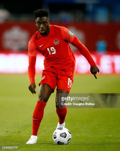 Alphonso Davies of Canada dribbles the ball during a 2022 World Cup Qualifying match against Honduras at BMO Field on September 2, 2021 in Toronto,...