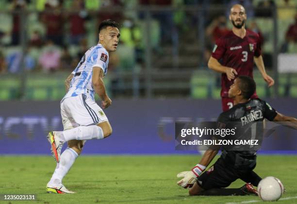 Argentina's Lautaro Martinez scores past Venezuela's goalkeeper Wuilker Farinez during their South American qualification football match for the FIFA...