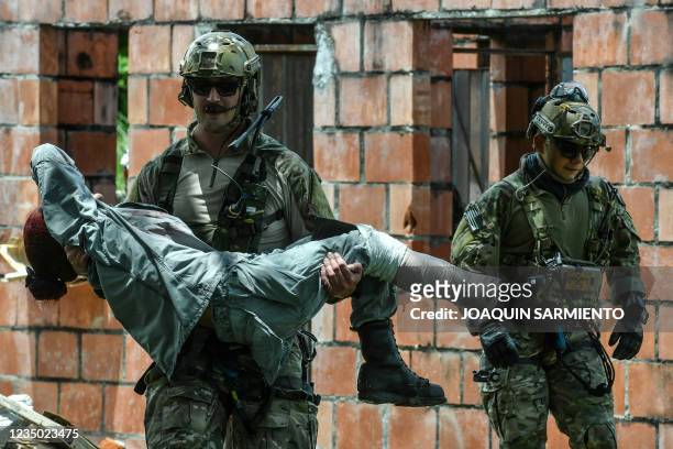 Medical staff from the United States Air Force carry a woman during an earthquake emergency drill with Air Force troops from Colombia, Brazil,...